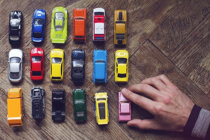 Line up of toy cars representing future of electric vehicles
